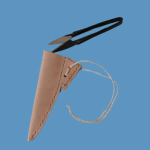 scissor snips emerging from a hand-made natural leather case