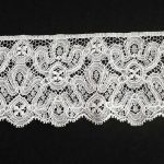Close-up of Stuart-era Milanese lace trim with intricate floral design